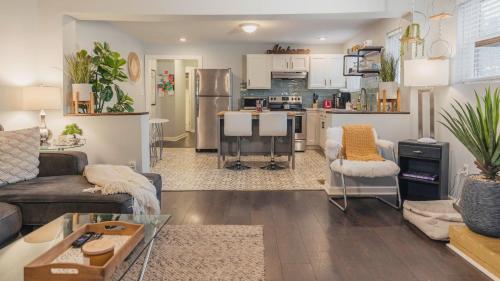 a living room with a couch and a kitchen at King bed open floorplan in heart of Bham in Birmingham