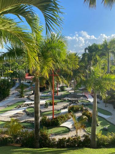 a view of a golf course with palm trees at Fajardo Inn Resort in Fajardo