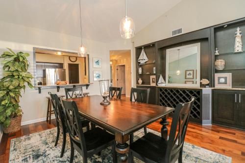 a dining room with a wooden table and chairs at Seaside at Anastasia A304 in St. Augustine