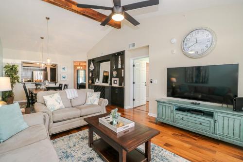 a living room with a couch and a tv at Seaside at Anastasia A304 in St. Augustine