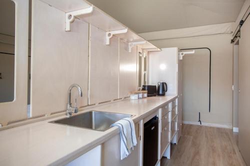 a kitchen with a sink and a counter at Crowdy Bay Eco Resort in Harrington