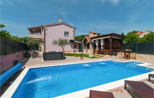 a swimming pool in the backyard of a house at Beautiful Home In Hrvace With Heated Swimming Pool in Hrvace