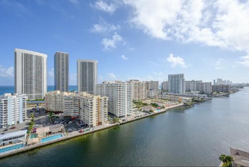 a view of a city with a river and buildings at Stunning Penthouse Suite Waterfront 2BD 2BA in Hallandale Beach