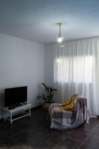 a living room with a flat screen tv and a table at Departamento NAMIVA II in Cordoba