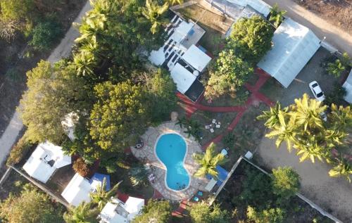an overhead view of a pool in a park with trees at Hacienda de Flores in Guayacanes