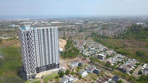 an overhead view of a large white building at Amartha View Apartement in Tambakaji