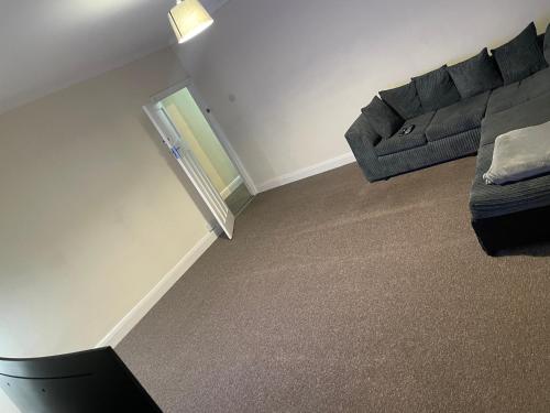 a living room with a couch and a chair at Welcome to your new home. in Redbridge
