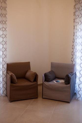 two chairs sitting next to each other in a room at CasaPaola b&b Rooms in Acireale