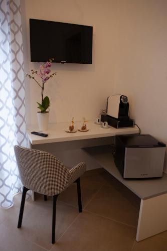 a room with a desk with a chair and a television at CasaPaola b&b Rooms in Acireale