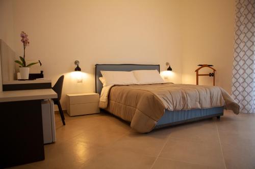 a bedroom with a bed with two lights on at CasaPaola b&b Rooms in Acireale
