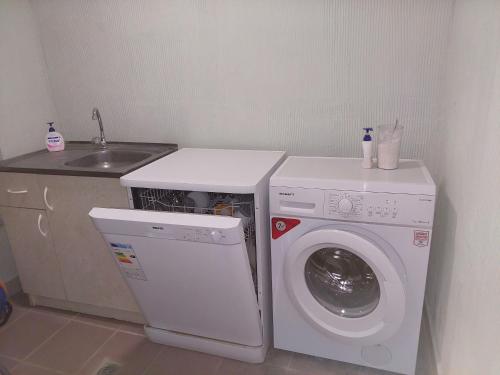 a kitchen with a washing machine and a sink at H&L Coworking and Live in Jrvezh