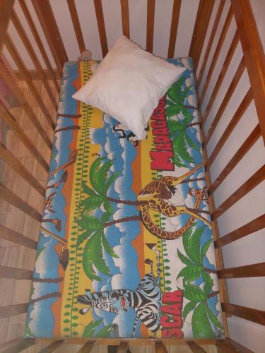 a bed with a colorful blanket and a pillow at H&L Coworking and Live in Jrvezh