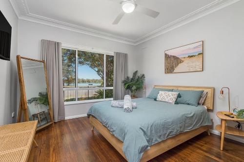 a bedroom with a bed and a large window at Banyandah in North Haven