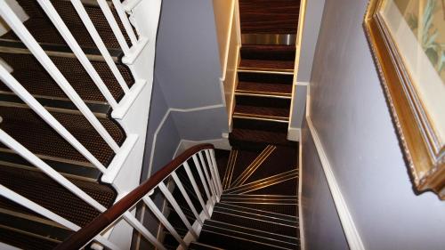 a spiral staircase in a home with black and white treads at Crestfield Hotel in London