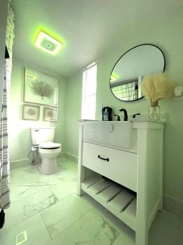 a bathroom with a sink and a mirror and a toilet at 4 miles to Siesta Key Beach #1 in America in Sarasota