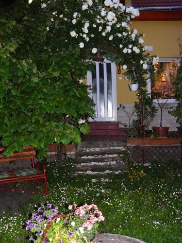 a front door of a house with a bunch of flowers at Angéla Vendegház in Tokaj