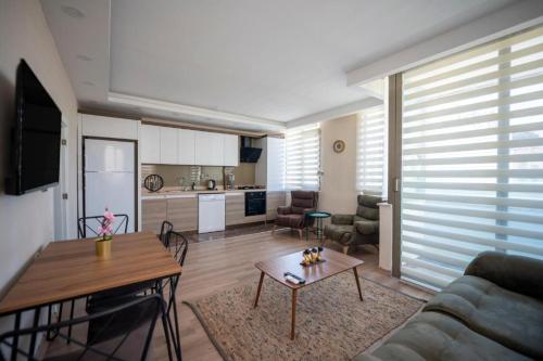 a living room with a couch and a table at ABC Apart Hotel in Antalya