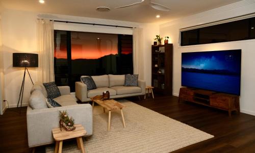 a living room with a couch and a large screen tv at Fletchers Ridge - Main House in Montville