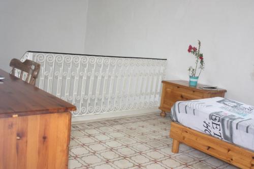 a room with a radiator and a table and a desk at VERTICAL CLIMBING MALTA in Qrendi