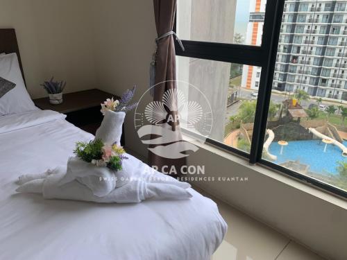 a bedroom with a bed and a window with a view at SG Resort Residences Kuantan by AP CA CON in Kampung Sungai Karang
