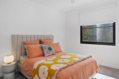 a bedroom with a bed and a window at Moggs Creek Luxury Escape in Aireys Inlet