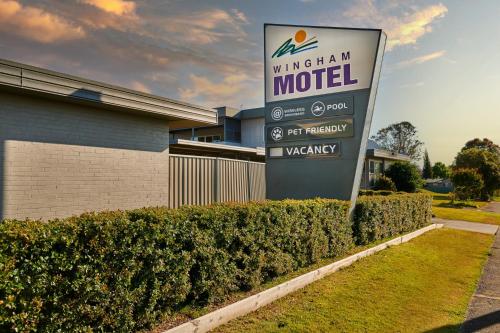 a sign for a motel in front of a building at Wingham Motel in Wingham