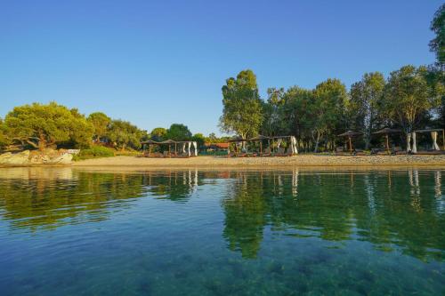 a park with a playground and a body of water at Serenity Estate in Ormos Panagias