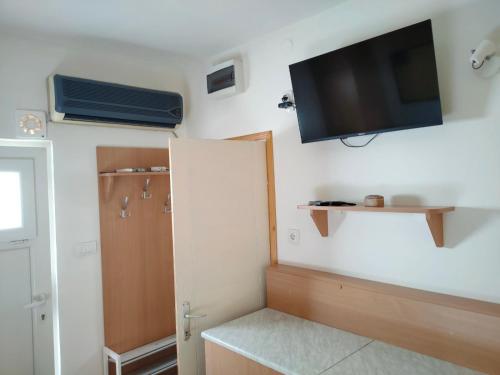 a room with a flat screen tv on the wall at Sobica in Sremska Kamenica