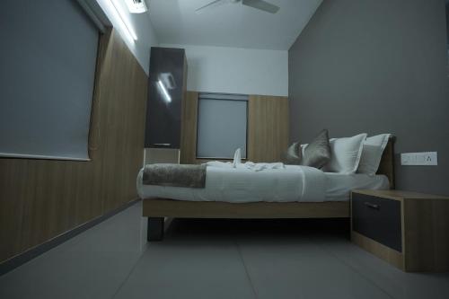 a bedroom with a large bed with white sheets and pillows at Lago Leisure Resort & Spa in Cherai Beach