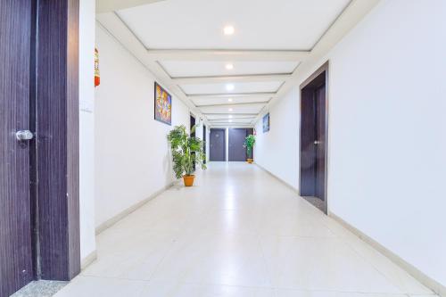 an empty corridor of a building with white walls at FabHotel Skyland in Ahmedabad