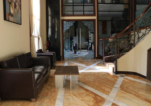 a living room with a couch and a coffee table at BW Kemayoran Hotel & Convention Powered by Archipelago in Jakarta