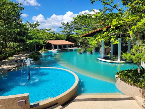 a pool at a resort with a fountain at Fernvale Leisure Club and Resort in Coron