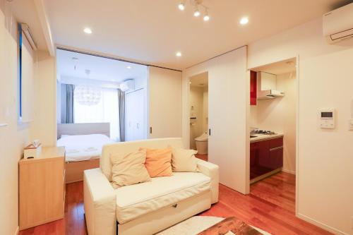 a living room with a couch and a bedroom at Space Roppongi in Tokyo