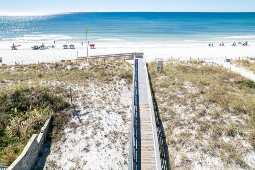a wooden boardwalk leading to a beach with the ocean at SeaCrest 413 condo in Fort Walton Beach
