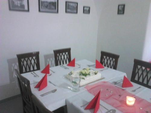 a table with red napkins on it with a cake on it at Hotel Berger in Kamenice nad Lipou