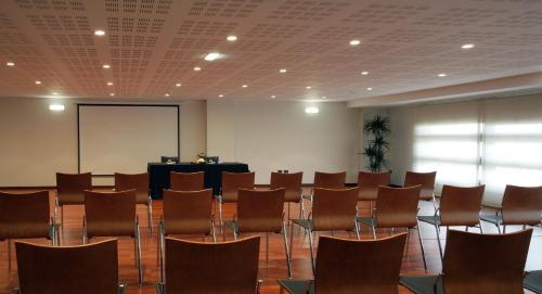 a large room with chairs and a podium in the background at Hotel Europa in Utebo