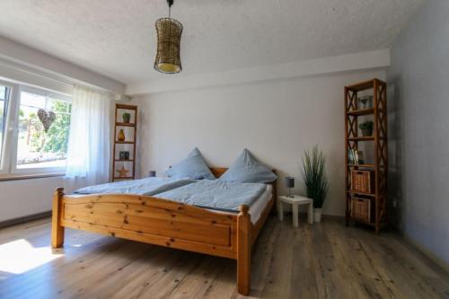 a bedroom with a wooden bed in a room at Ferienwohnung Schöne Aussicht am Rothaarsteig in Bad Laasphe