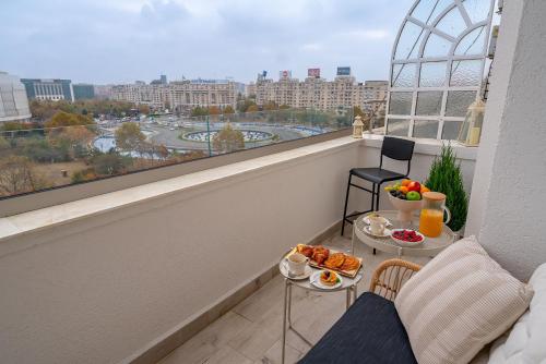 a balcony with a table with food on it at Style and view Bucharest city center aparthotel in Bucharest