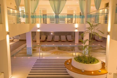 a hotel lobby with a plant in a pot at Aranwa Paracas Resort & Spa in Paracas