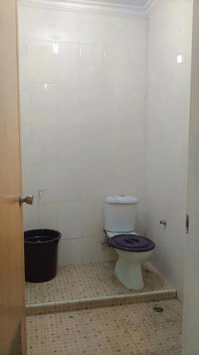 a bathroom with a toilet and a bucket in it at Villa MountView No 88 Berastagi View in Berastagi