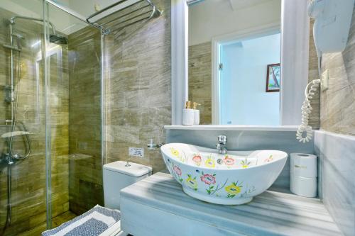 a bathroom with a tub and a shower and a sink at Lido Corfu Sun Hotel 4 Stars All-inclusive in Benitses