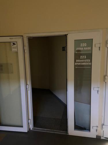 eine offene Fahrstuhltür mit Schild drauf in der Unterkunft Draugystės apartmentai in Kaunas