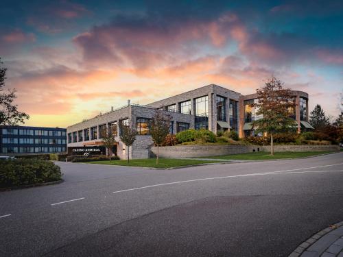 a large building with a road in front of it at Van der Valk Hotel Heerlen in Heerlen