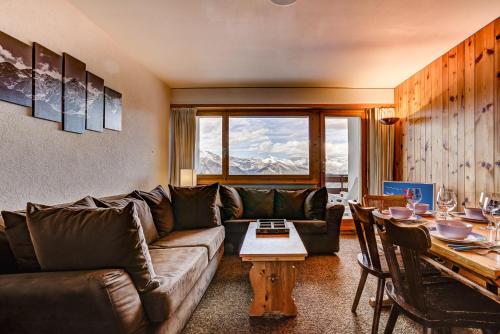a living room with a couch and a table at Appartement Mont Parrain 14 in La Tzoumaz