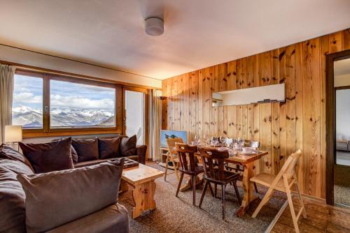 a living room with a couch and a table at Appartement Mont Parrain 14 in La Tzoumaz