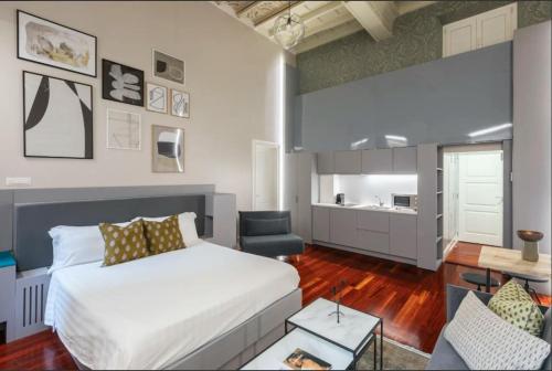 a bedroom with a bed and a living room at Croce Apartments in Rome