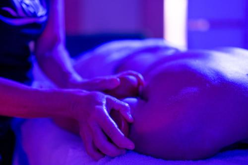 a person laying on a bed with their hand on a persons stomach at Casa Vacanze Fiore di Loto in Leporano