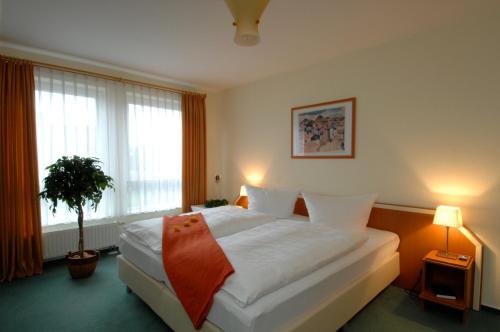 Ένα ή περισσότερα κρεβάτια σε δωμάτιο στο Grothenns Hotel 3-Sterne superior