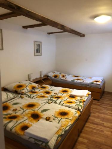 two beds in a room with sunflower beds at U Monka in Jáchymov