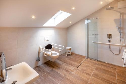 a bathroom with a shower and a toilet and a sink at Monusse Boid Wohnung 12 in Pfronten